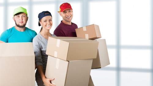 Packed office boxes and labeled furniture ready for an office move in Hackney
